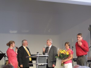 Church leadership team presents Pastor Peter with congratulatory bouquet