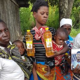 A woman and her children receiving help after a natural disaster in South Africa