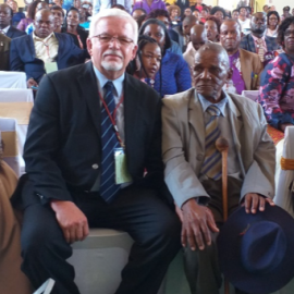 Joe Delport sitting with 98 year old First Bishop of Botswana