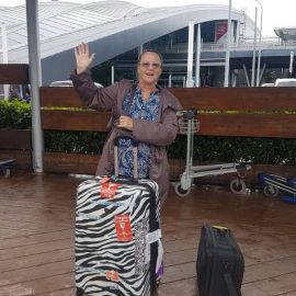 Althea Meyer waving at the camera as she leaves from airport 