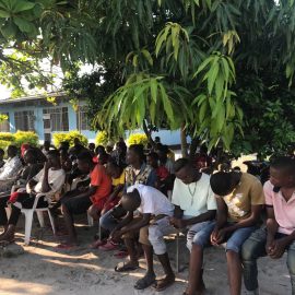 People praying at the Saturday meal