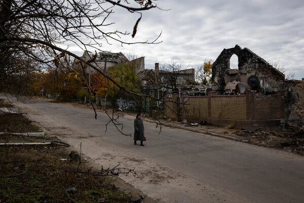 Woman walks through destroyed Ukrainian City