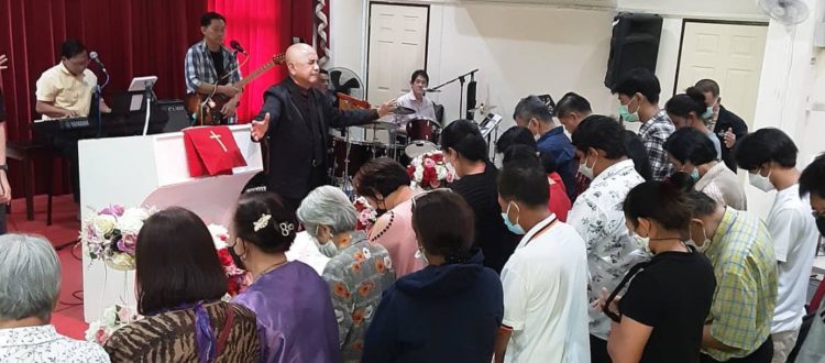 Albert praying for various needs of Don Miuang Church