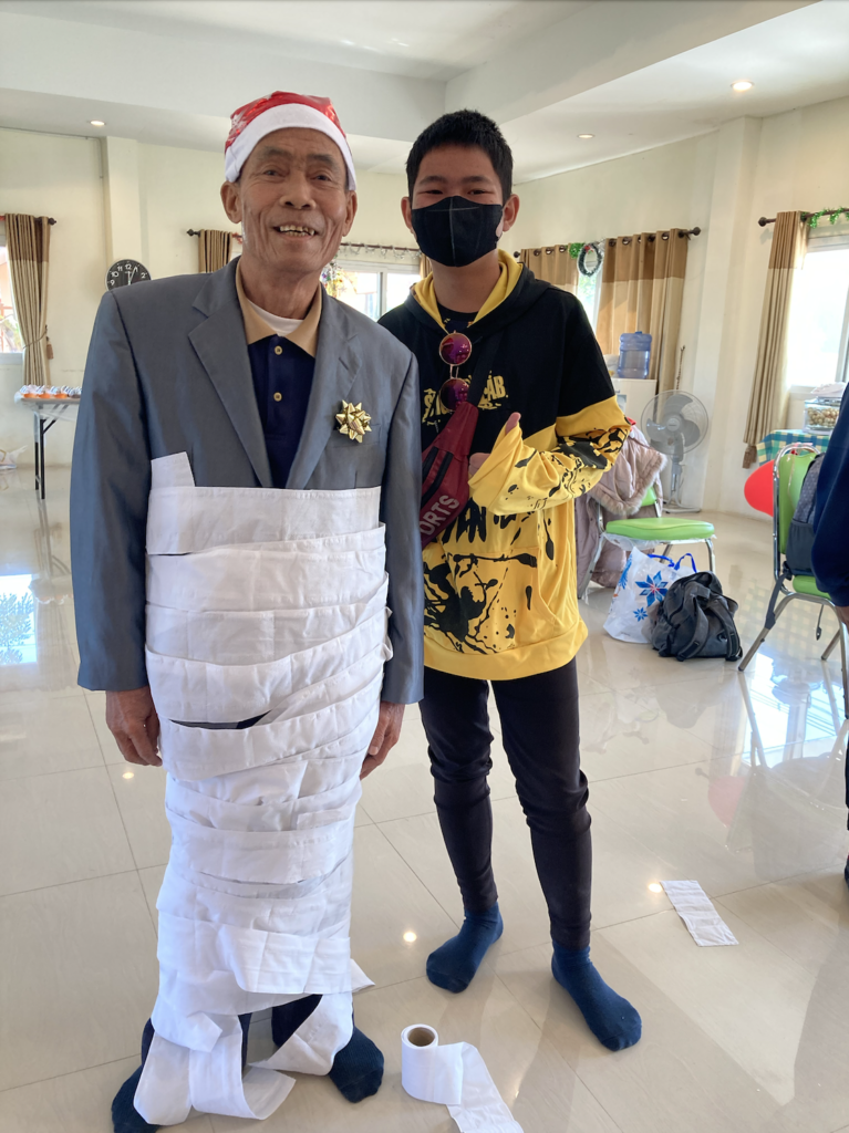 Uncle Tham, winner of the “Wrap the Present” game.