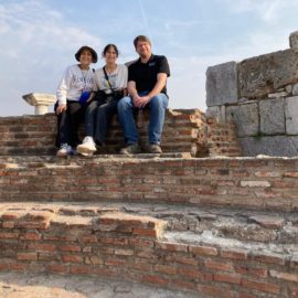 The Wests sitting on a wall in Ephesus.