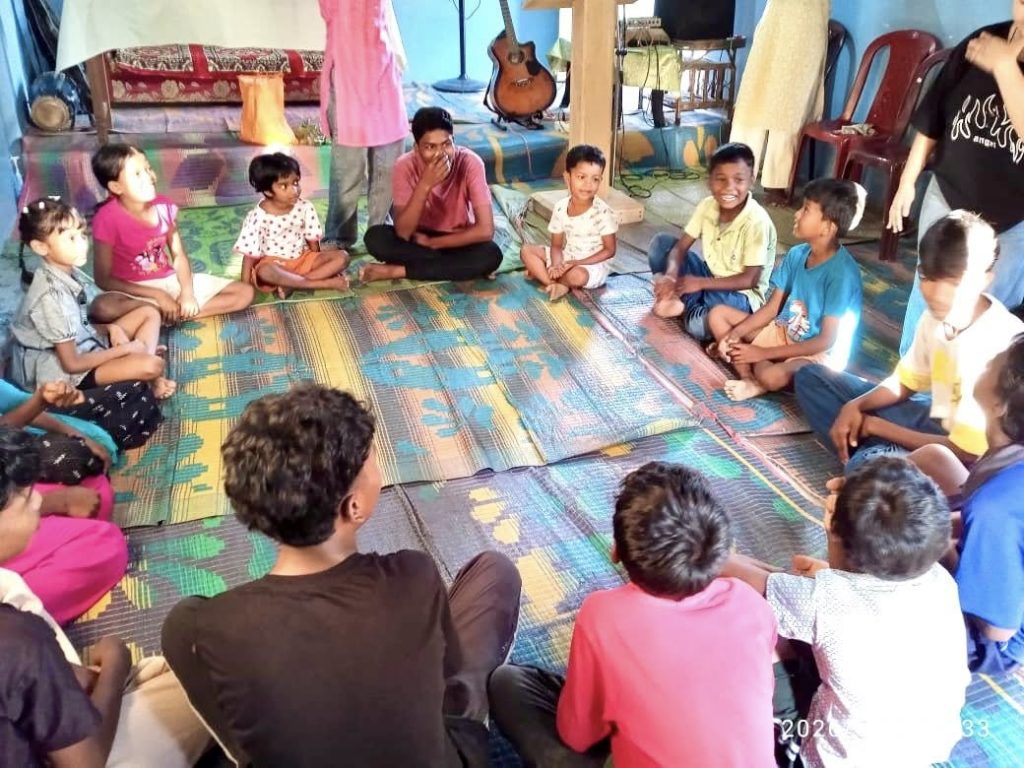 a group of children sitting on the floor in a room