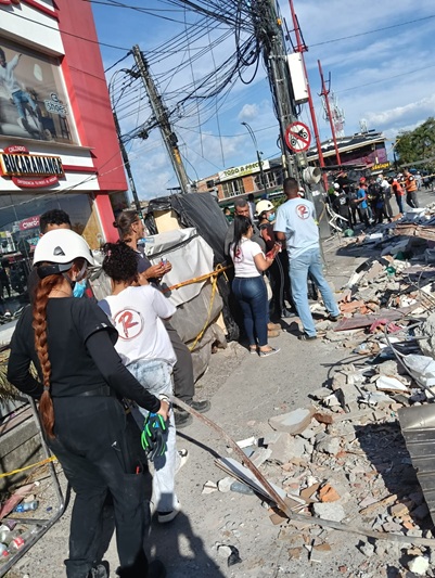people in street by rubble