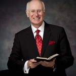 Black Suit Red Tie Holding Open Bible 1